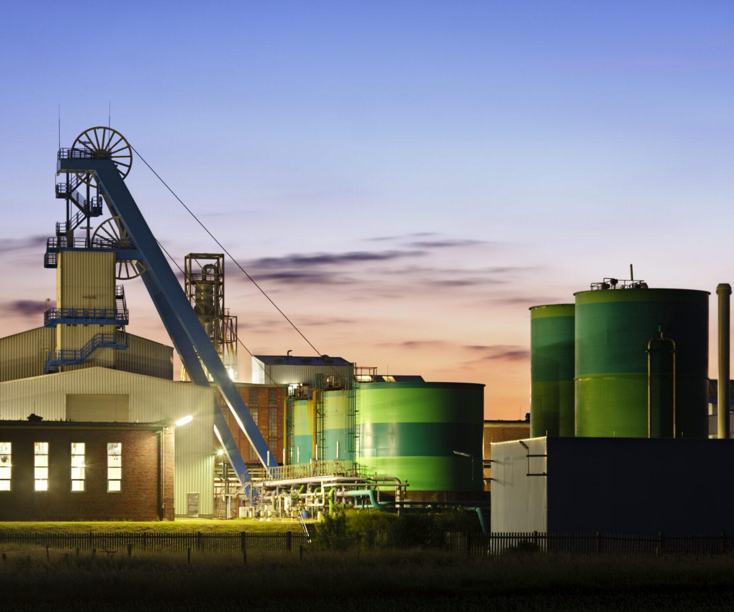 Salt mine with winding tower shortly after sunset.